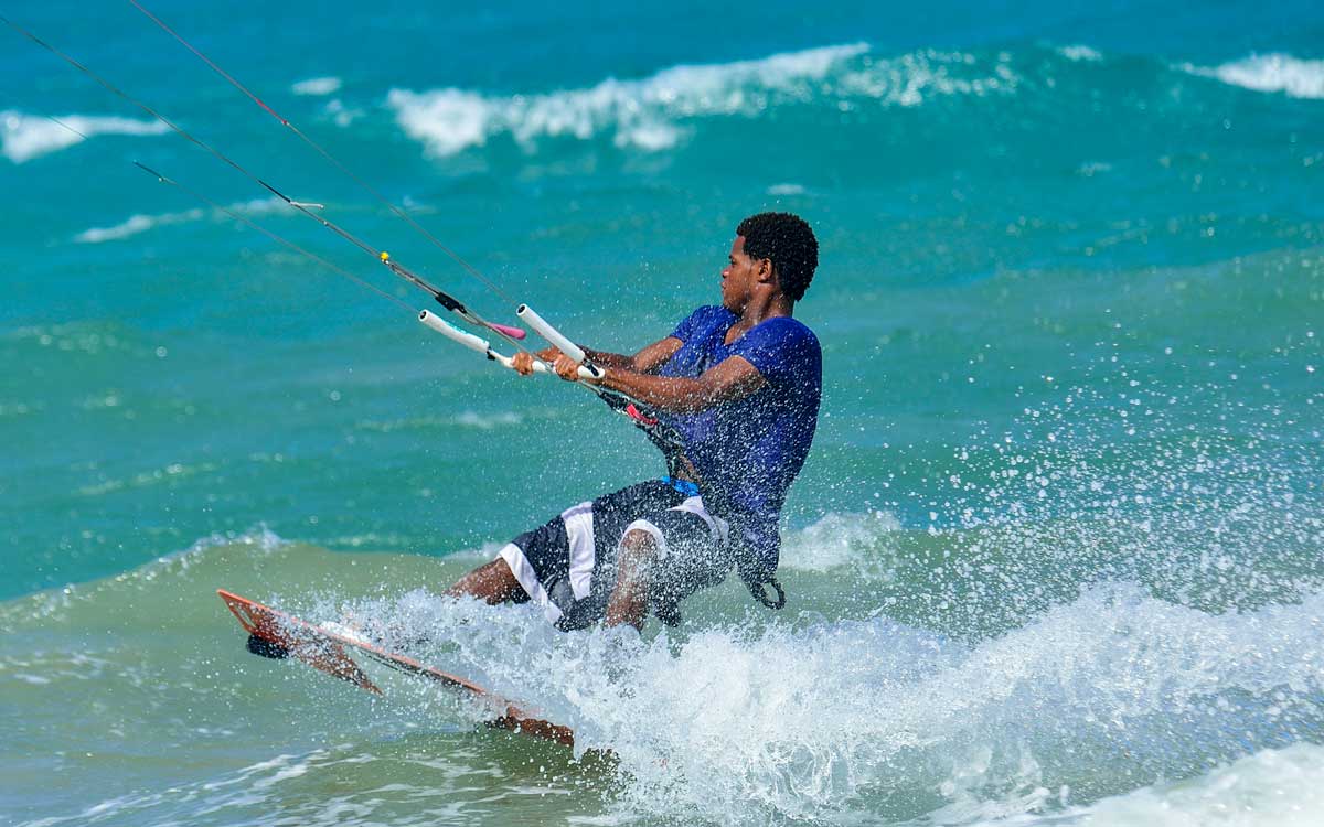 Kite surfer riding waves.
