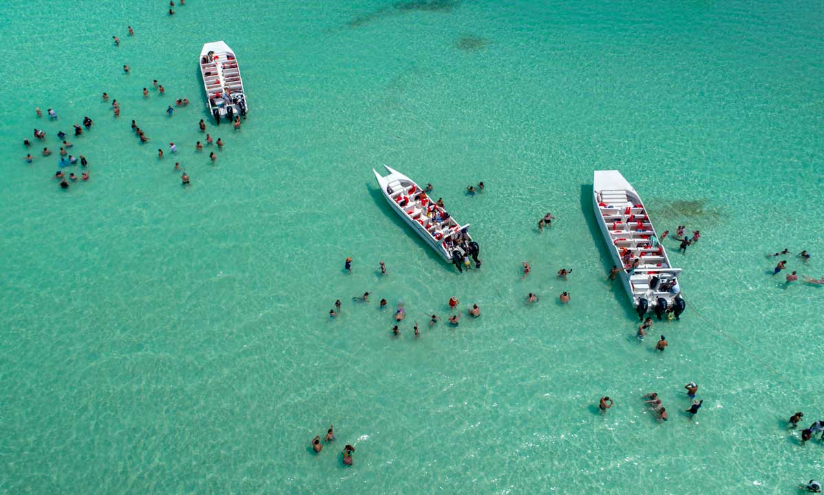 Tourists swimming in Saona Island.