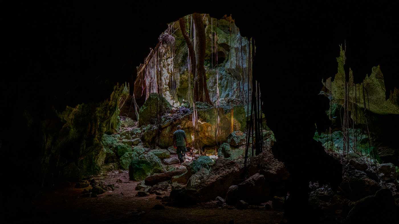 Man exploring cave.