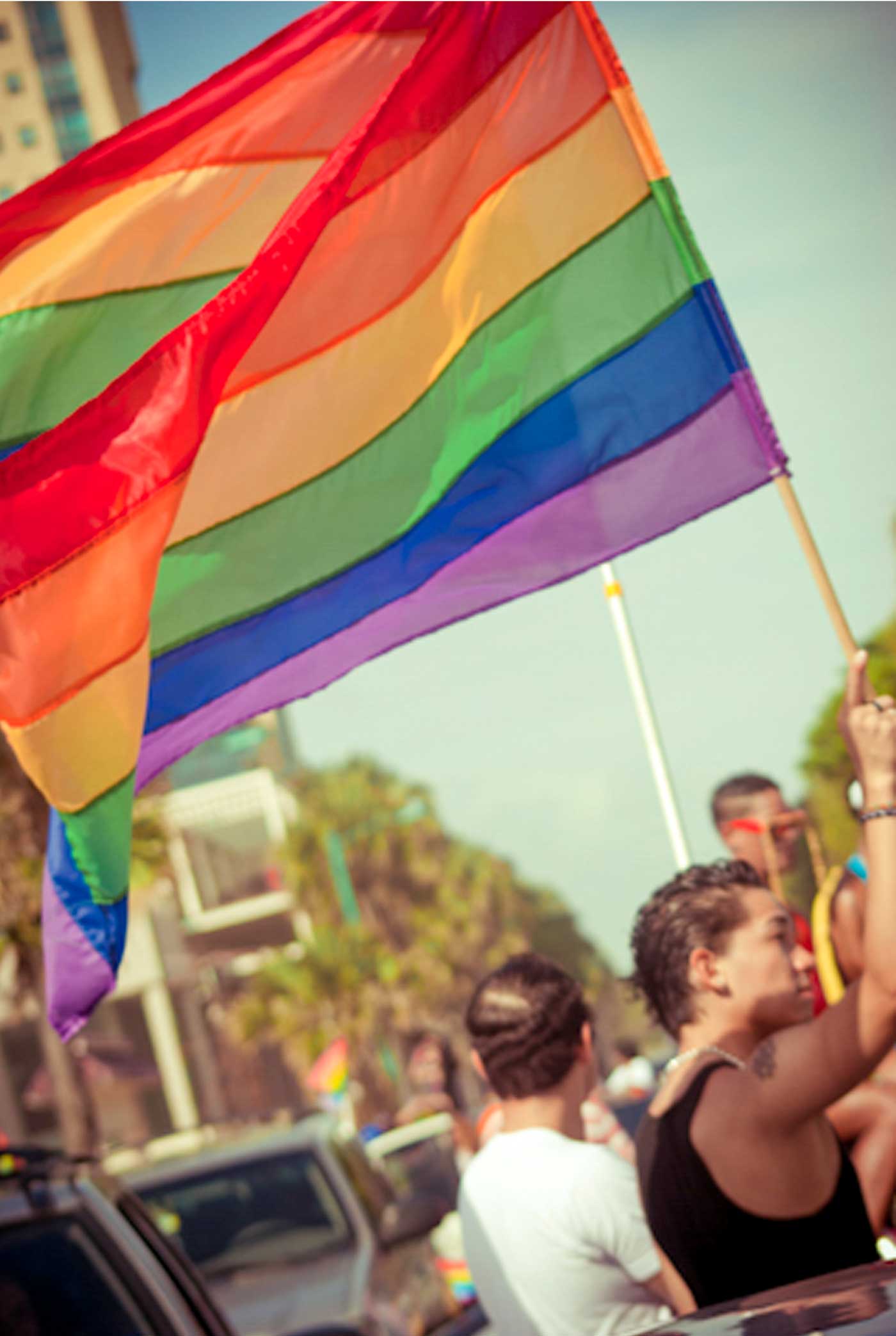Man holding rainbow flag.