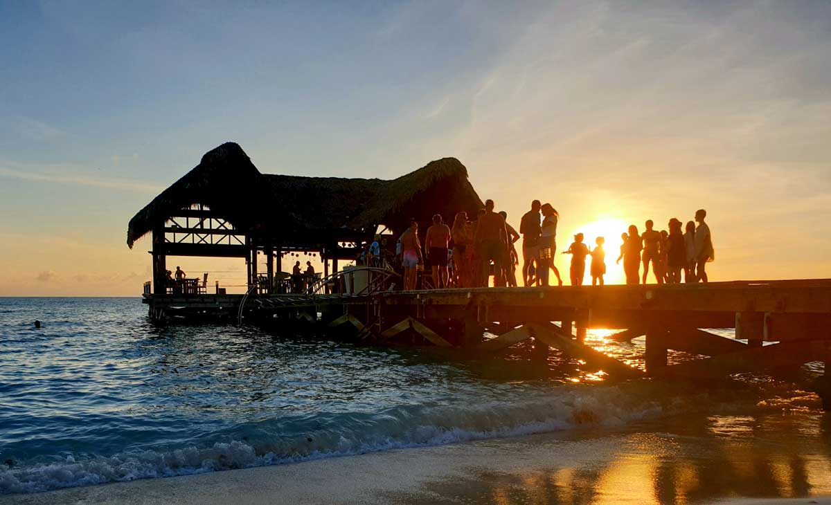 Pier with people gathered at sunset.